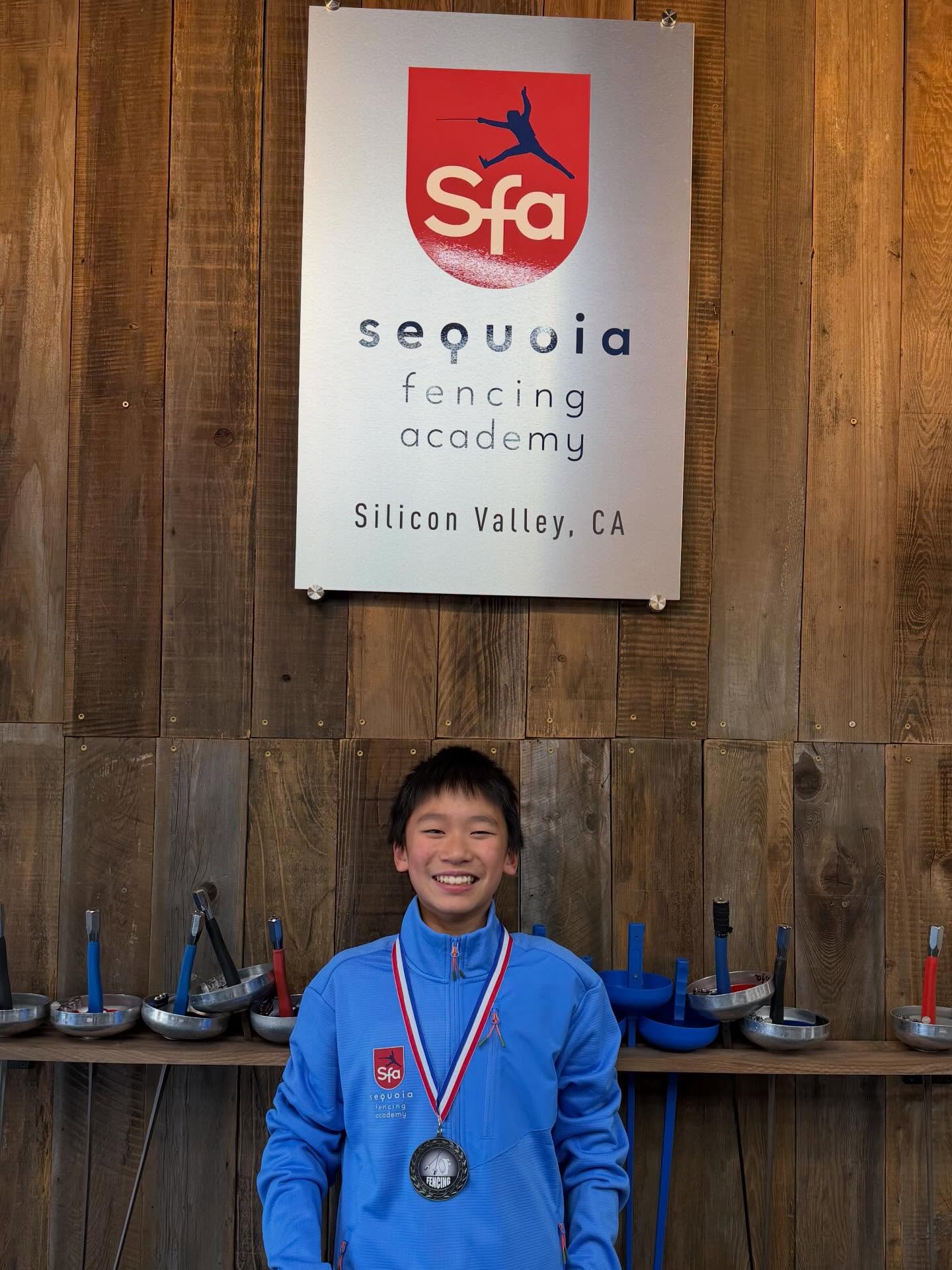 Sequoia Fencing Academy athlete with a medal at a fencing competition