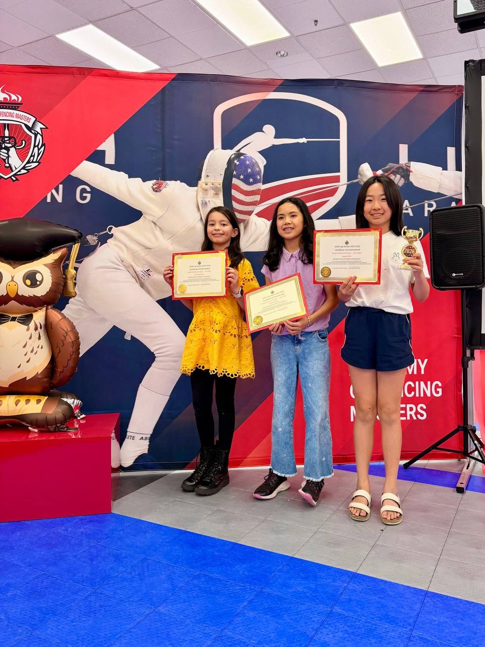 Sequoia Fencing Academy athlete holding a championship cup