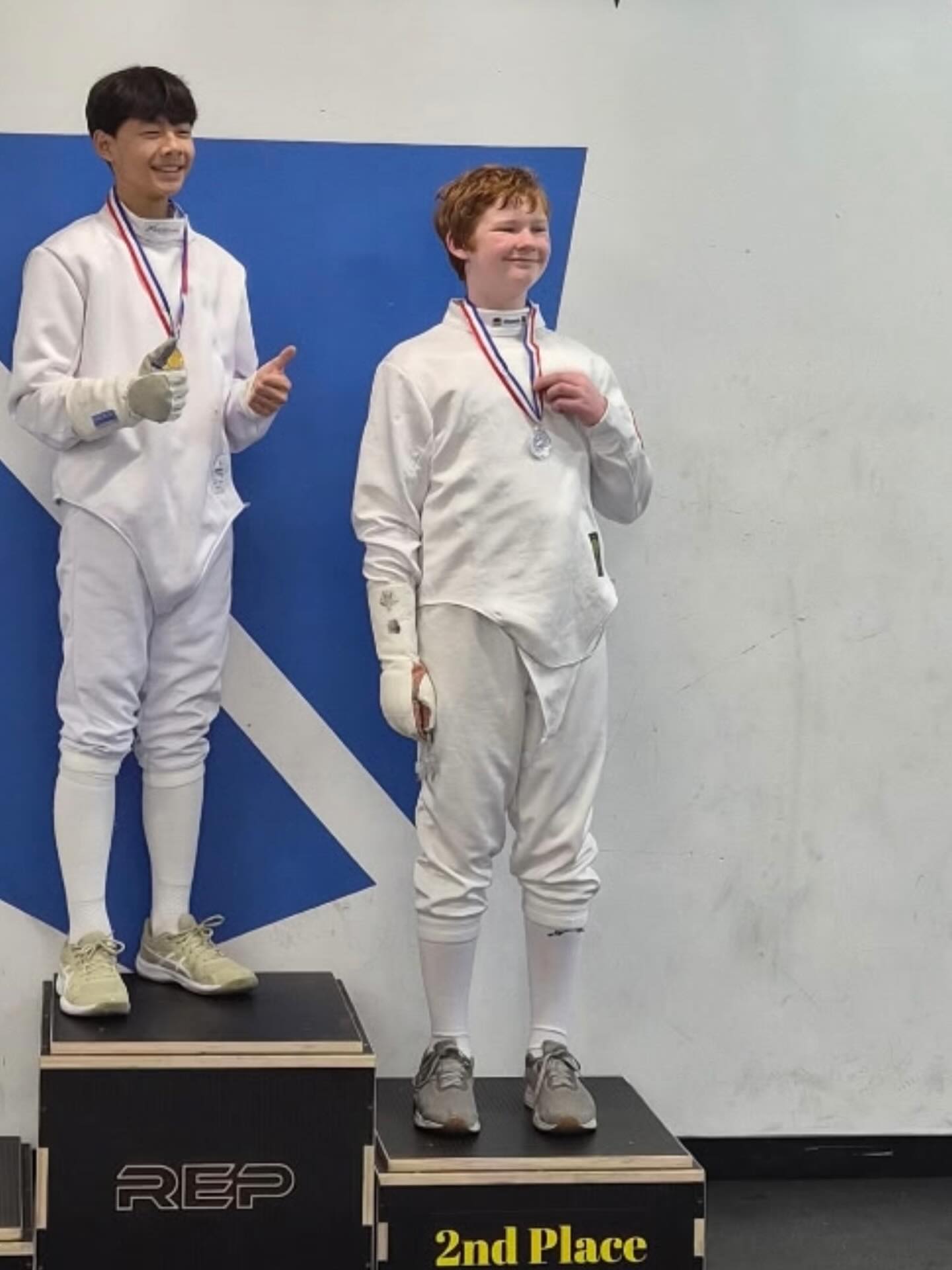 Sequoia Fencing Academy athlete proudly displaying a fencing medal