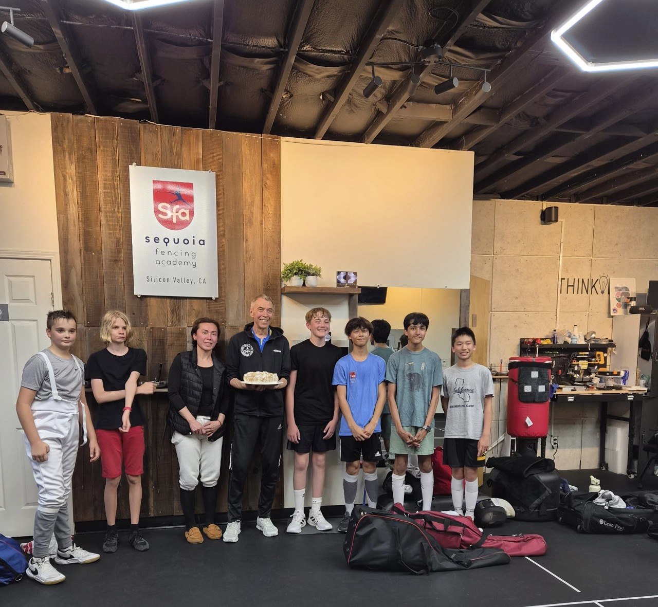 Sequoia Fencing Academy athletes and Coach Yuriy Mazur together at a training session