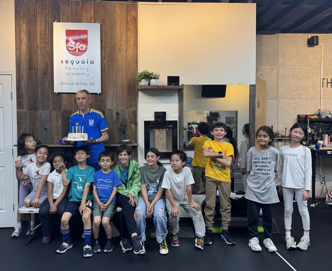 Sequoia Fencing Academy fencers gathered as a group with their coach